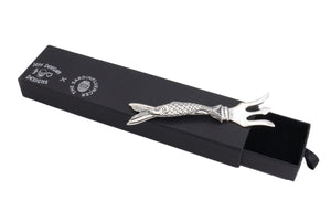 Image of the fish handled sardine fork on top of the black paperboard presentation box with slide out drawer.