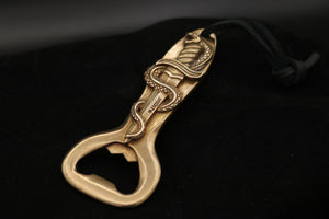 Dramitically lit front view of the bronze Snake Dagger Bottle Opener in bronze with leather thong cord