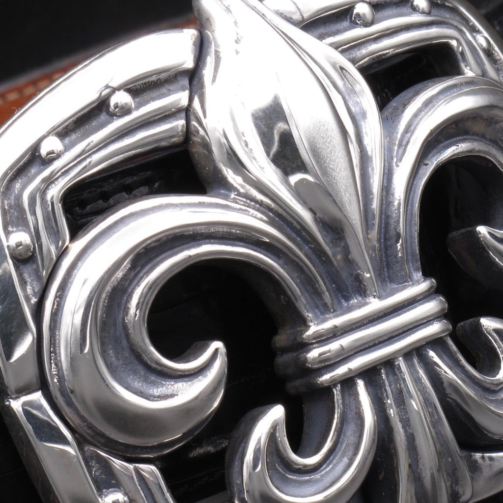 Closeup image of the detail of the Fleur di Li buckle in sterling for 1.5" straps.