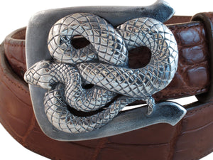 Coiled Snake buckle rests on a wrapped rust colored Alligator strap