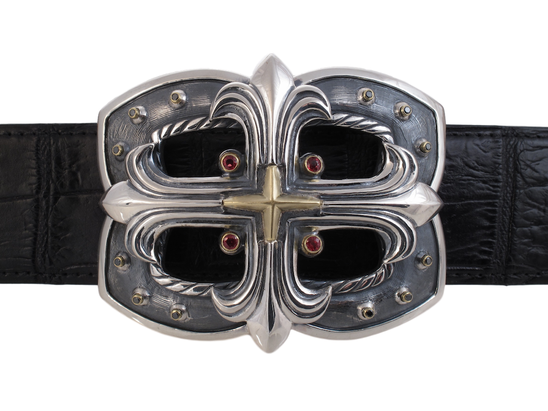 The Custom Collection of buckles is represented by this customized version of style #1335. This has beeen made with the addition of orange sapphires and black diamonds set in 18k bezels. a centre cross of 18K is set on the underlying sterling buckle.