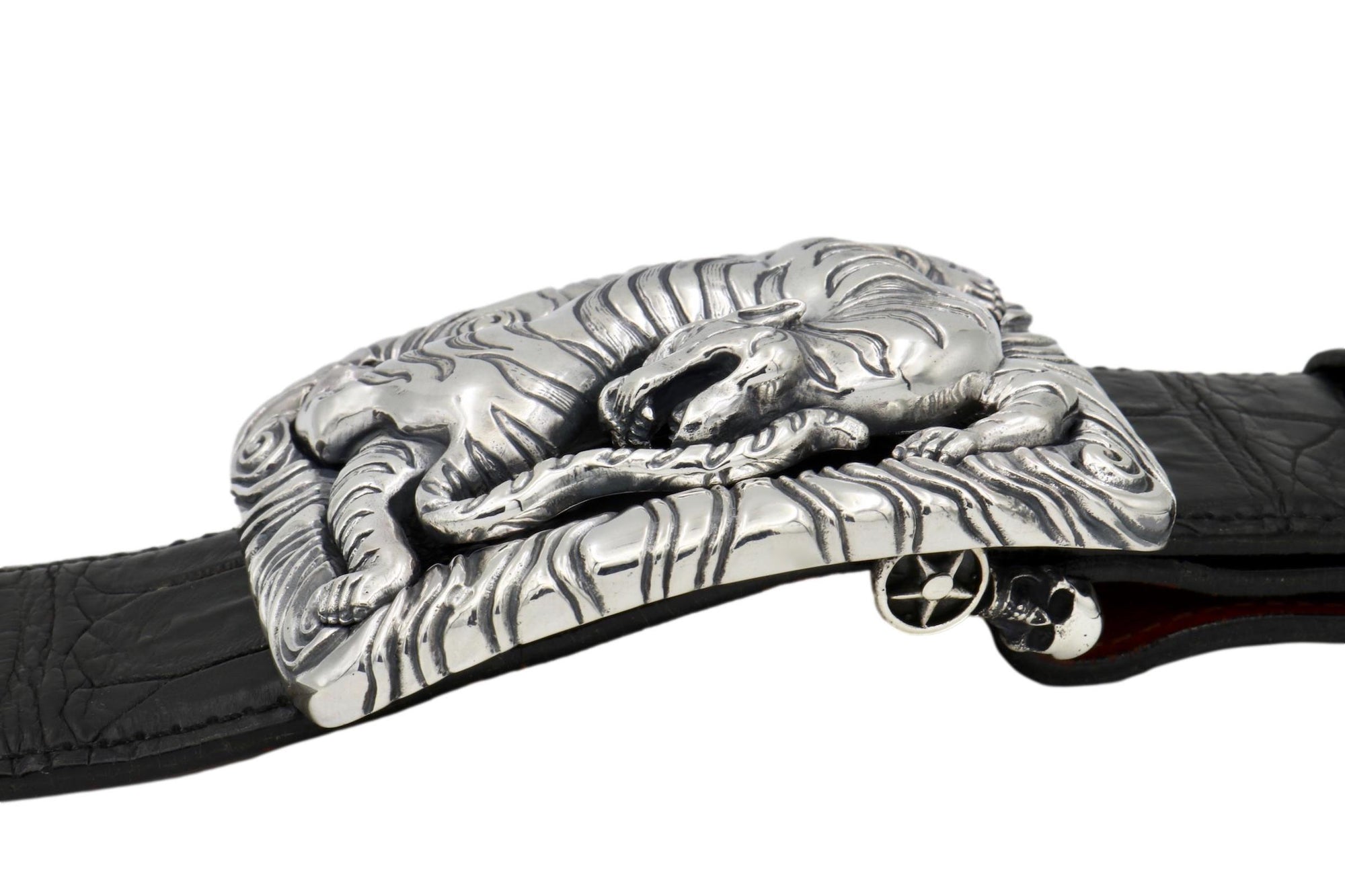 Front view of the Back Flipping Tiger buckle, showing the Tiger set into the elaborately carved surrounding frame. On a black alligator belt.