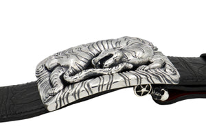 Side view of the Back Flipping Tiger trophy buckle in sterling.. This view of the buckle shown on a blacck alligator belt illustrates the dimensionality of the sculpted Tiger, as well as, the Skull Swing Bar as attached to the black alligator strap.