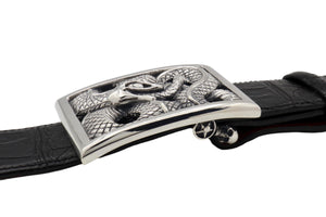 The Ouroboros Rectangular Frame buckle, in Sterling, shown in side view on a black alligator 1.5" belt. Visible is the Skull Swing Bar underneath.