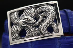 The Rectangular Framed Ouroboros Snake in dramatic closeup . Shown on an electric blue alligator belt.