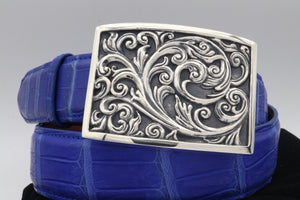 The Strling Carved Scroll Plaque buckle is shown here on a coiled electric blue alligator belt.