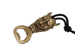 Bronze Hanya Mask Bottle Opener with a leather cord attached.