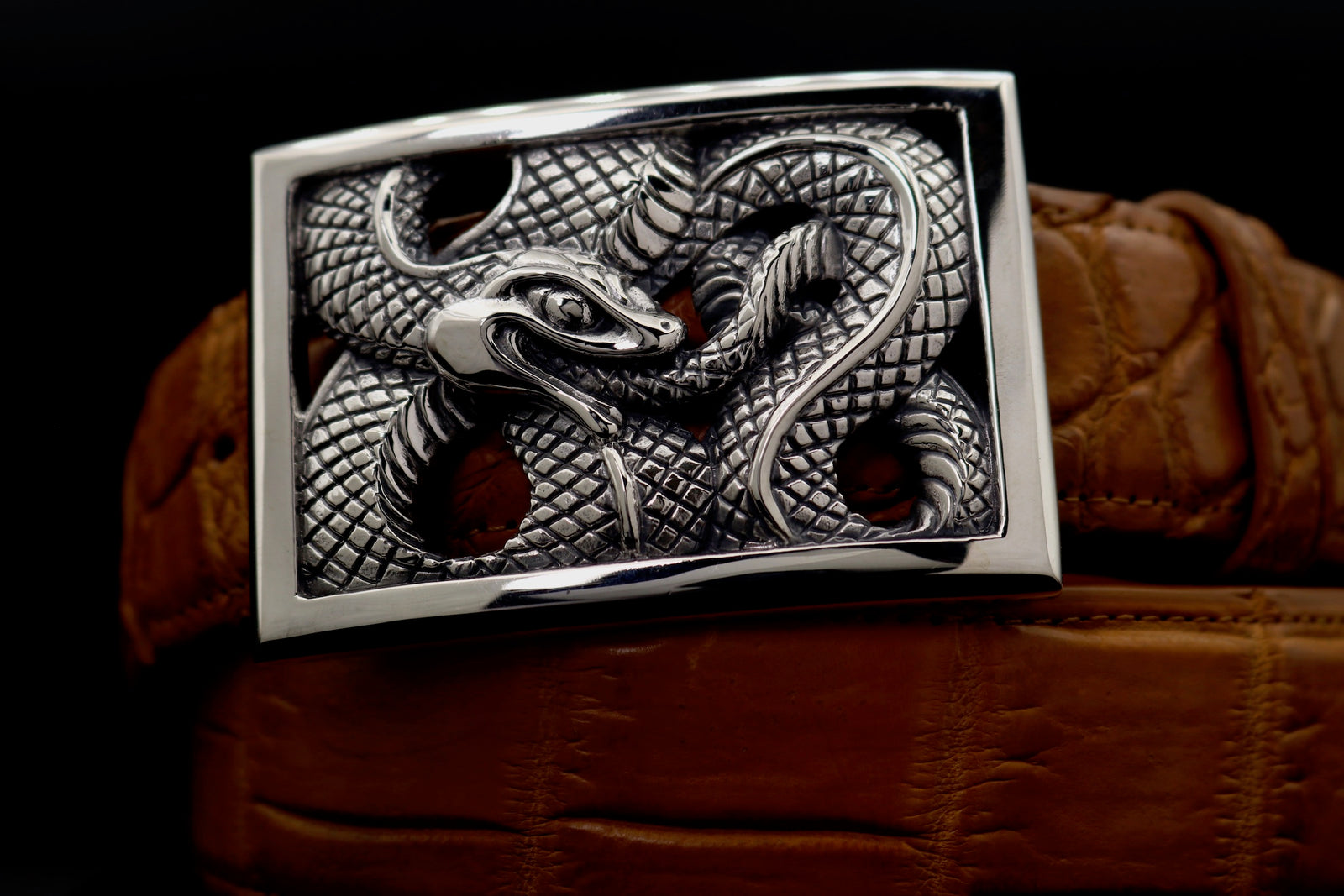 Front view of the Sterling  Ouroboros Rectangular Frame buckle on a black 1.5" belt.