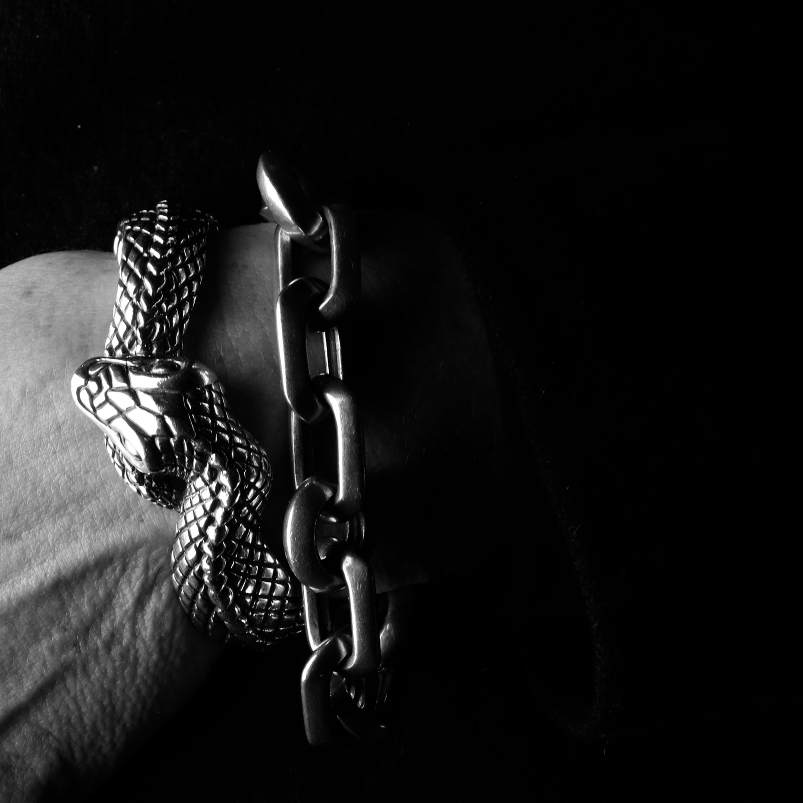 Featuring 2 Sterling Silver bracelets, the Snake cuff paired with one of the Chunky Link Chain Bracelets of round and rectangular sculpted links.