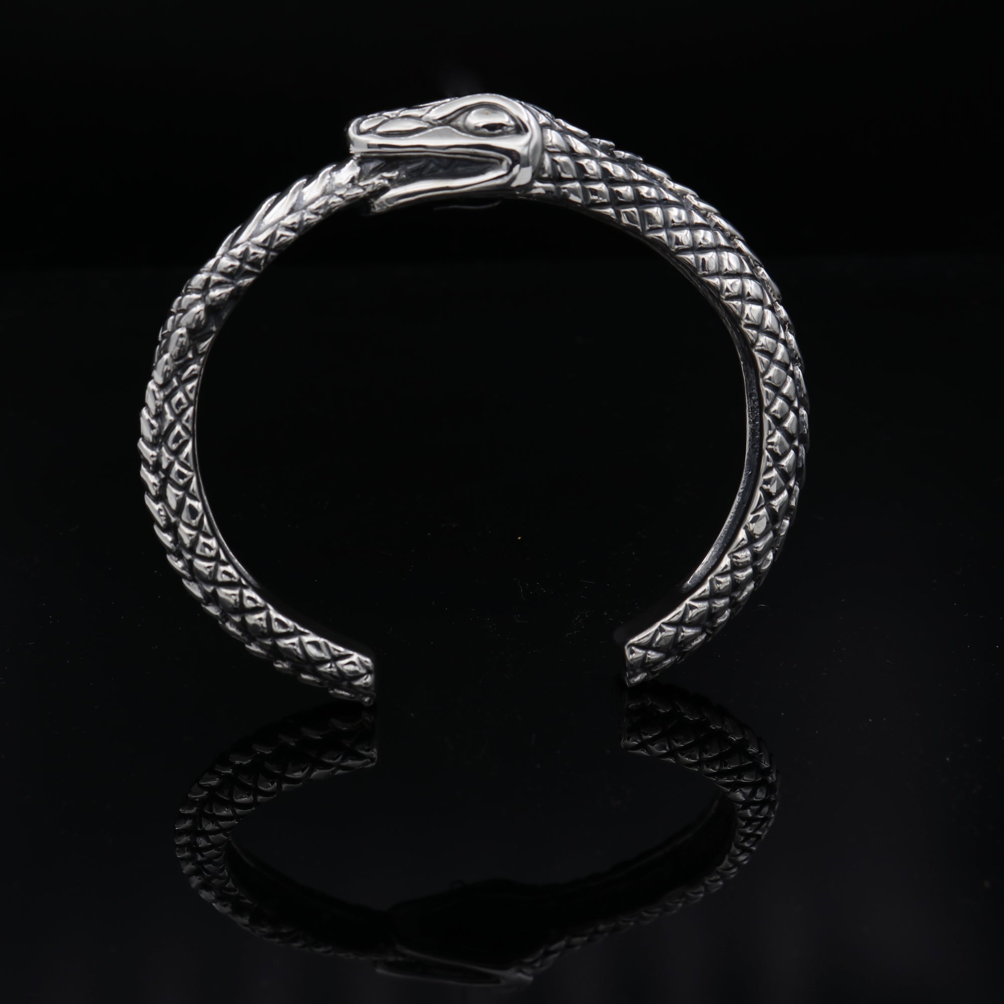 Ouroboros Cuff in Sterling Silver. The Ouroboros Snake deign is symbolic of the cycles of death and rebirth. Available in 3 wrist sizes.