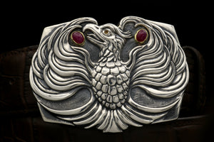 The Phoenix sterling buckle accented with 18kt gold bezel set ruby cabs and a dark yellow spessaratine eye.