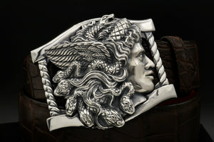 Sterling buckle Medusa head, carved as a side view. It sits on a base frame accented with twist detail. Shown on a brown alligator belt.