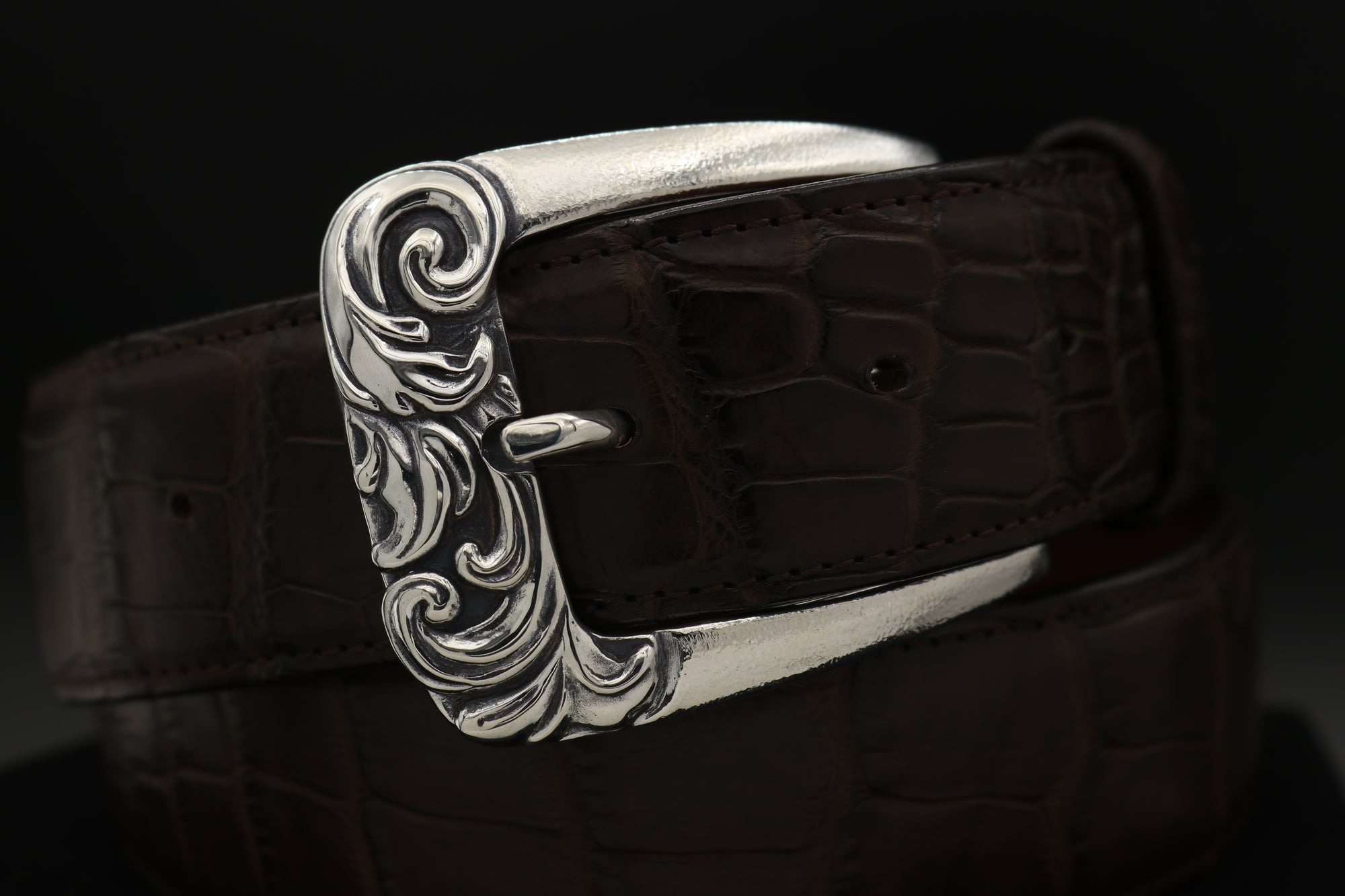 Classic Sterling harness style buckle with deep carved scroll design on front. Top view.