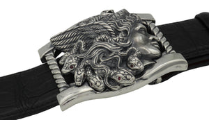 Sterling buckle Medusa head with Ruby eyed snakes, carved as a side view. Each writhing snake in her hair has rubies for eyes. It sits on a base frame accented with twist detail. Side view.