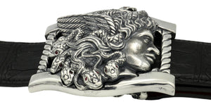 Sterling buckle Medusa head with Ruby eyed snakes, carved as a side view. Each writhing snake in her hair has rubies for eyes. It sits on a base frame accented with twist detail.