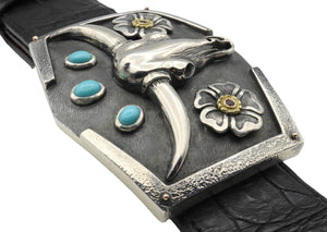 Angled view of the Steer Skull sterling buckle with turquoise and rubies.