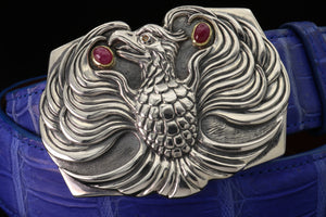 The Phoenix sterling buckle accented with 18kt gold bezel set ruby cabs and a dark yellow spessaratine eye.