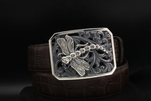 Belt with a detailed dragonfly buckle on a black background