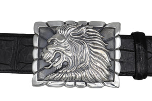 Sterling belt buckle on belt strap. Heraldic style Lion's head in profile. Sculpted in high relief atop a rectangular trophy buckle base that is textured with polished edging.  Fits 1.5" strap.