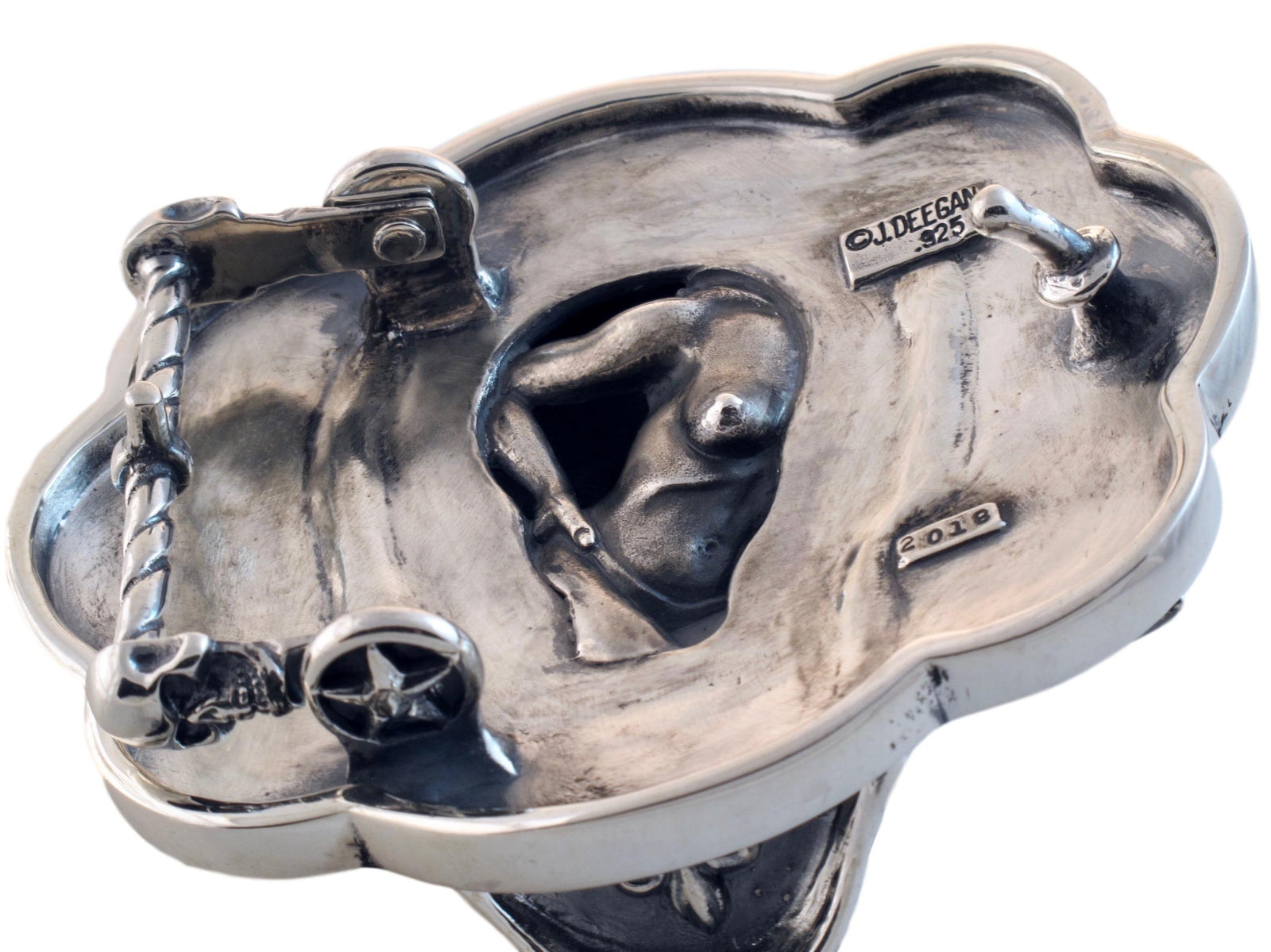 Front view of the Sugar Skull Trophy buckle in sterling and floral eyes set with Rubies in 18k bezel settings.