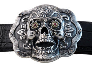 Front view of the Sugar Skull Trophy buckle in sterling and floral eyes set with Rubies in 18k bezel settings.