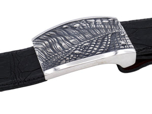 Side view of the sterling T Rex Skin plaque buckle on black alligator strap.